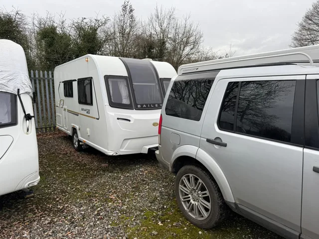 Touring caravan and tow vehicle among other parked caravans